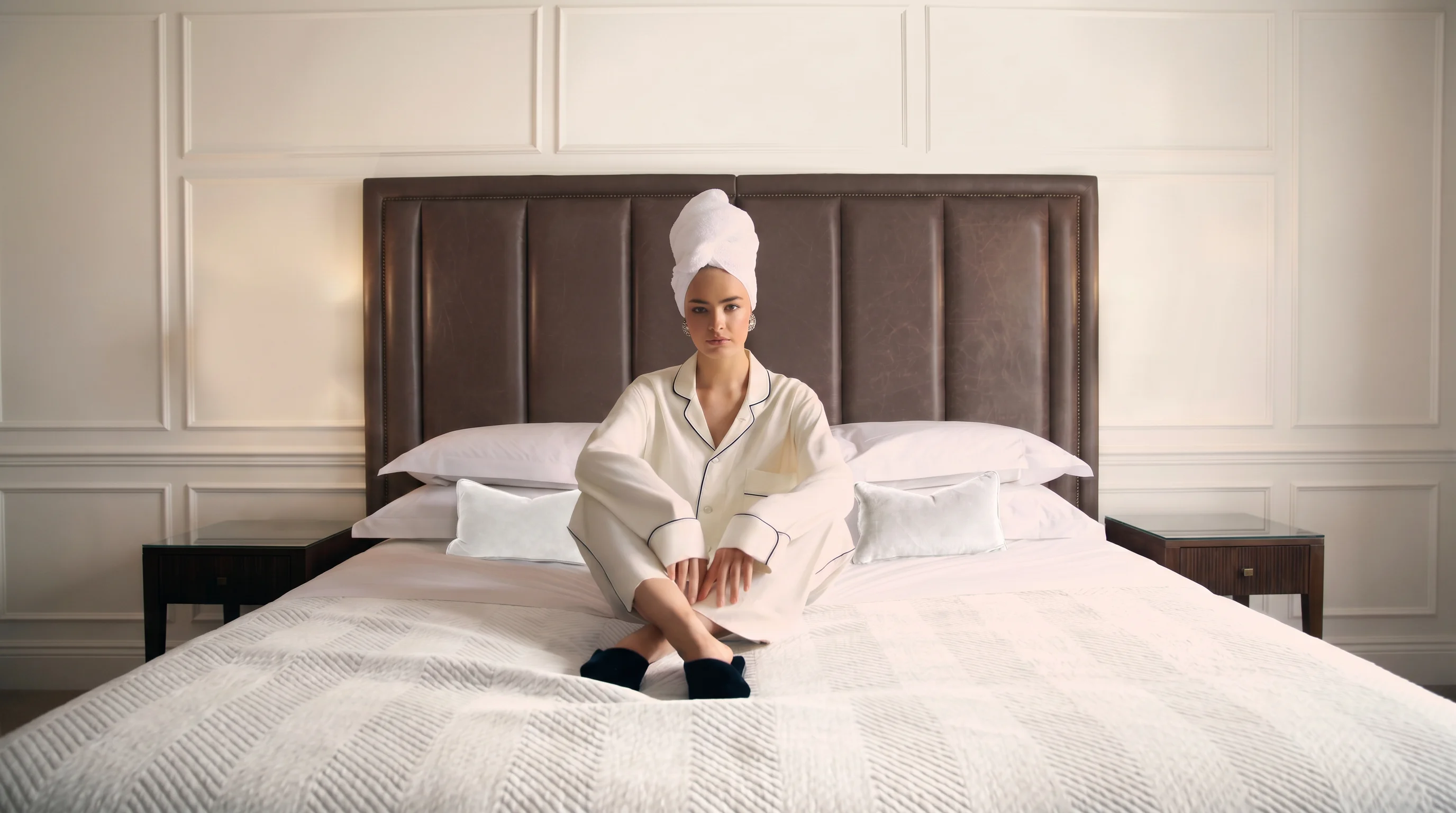 Guest in a hotel bed with plush amenities